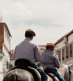  A vertical shot f two men riding horses around the city