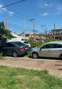 Veículos estacionados em parte de praça na Baixada Campista